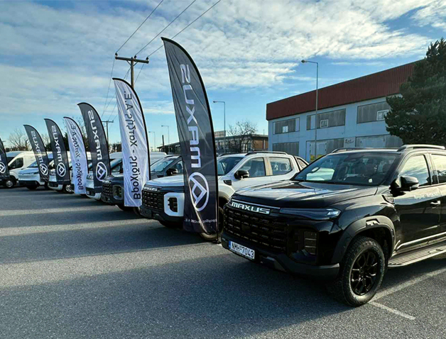 Maxus pickup trucks displayed outdoors at Βροχίδης Χατζής dealership.